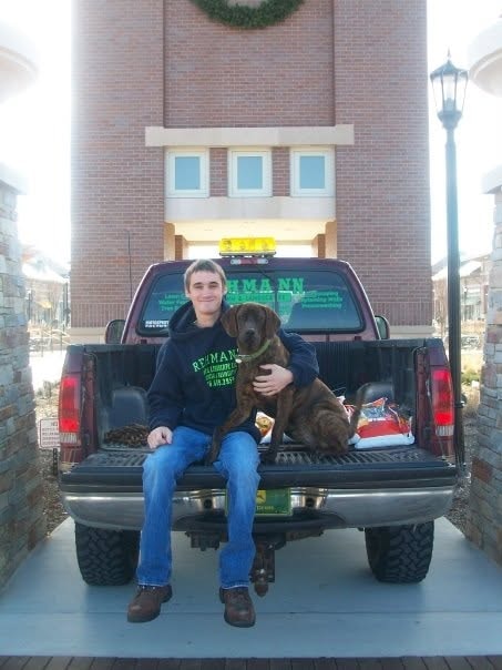 Mitchell at 19 with his Rehmann Lawn & Landscape truck
