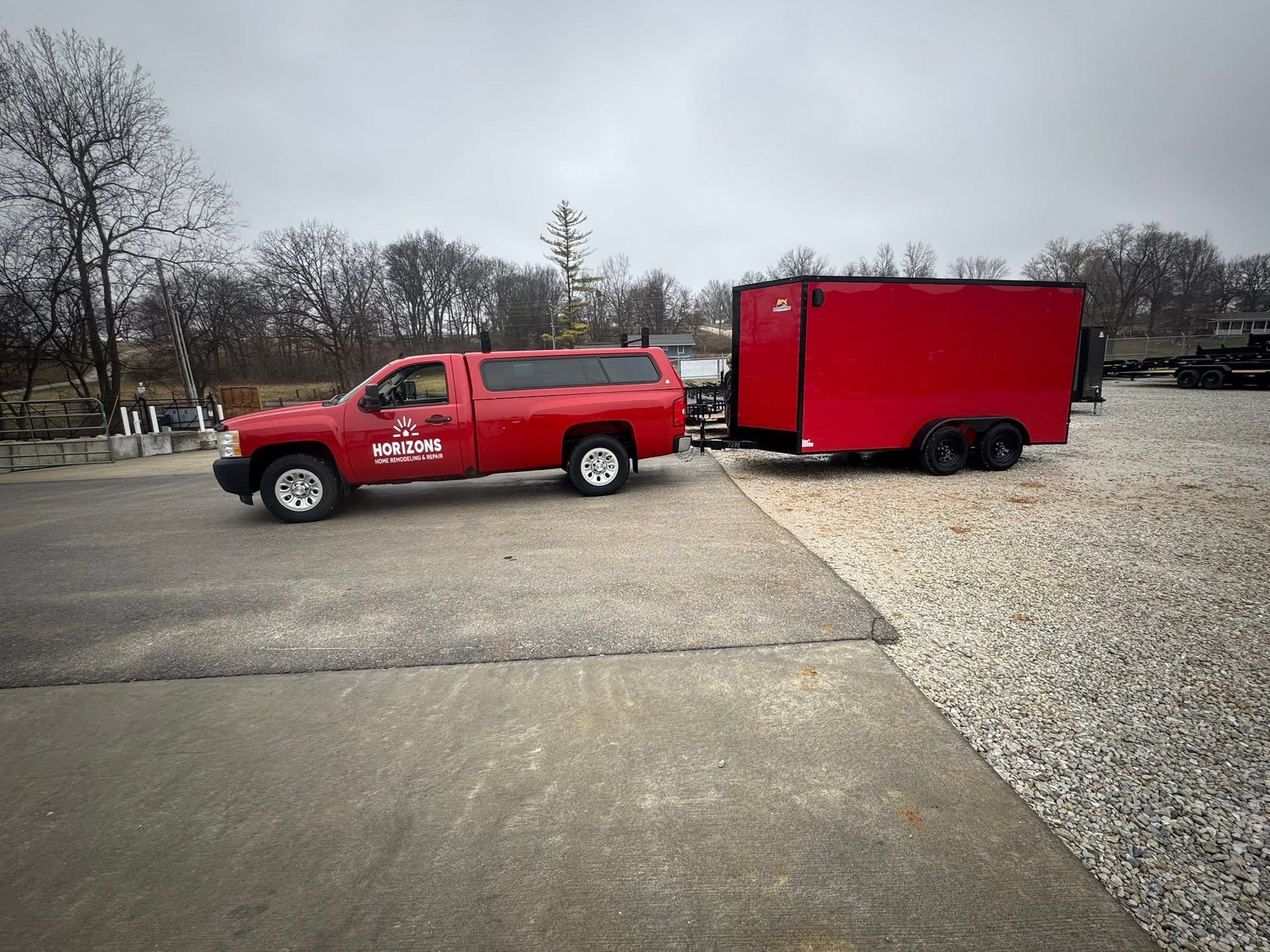 Horizons Home Remodeling truck hauling a red enclosed trailer